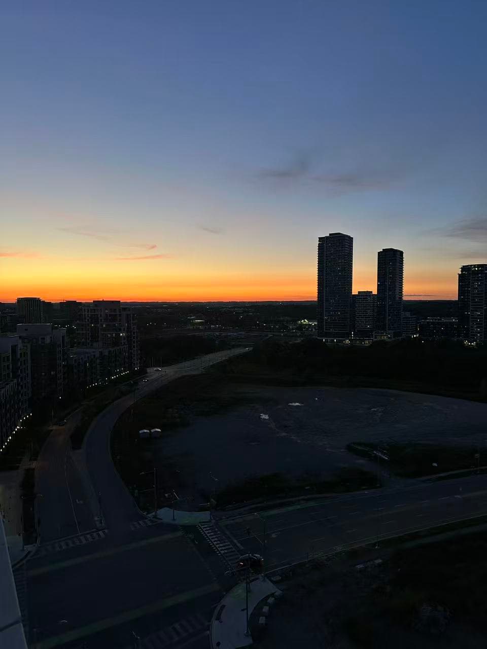 Sunset above neighbourhood streets and towers